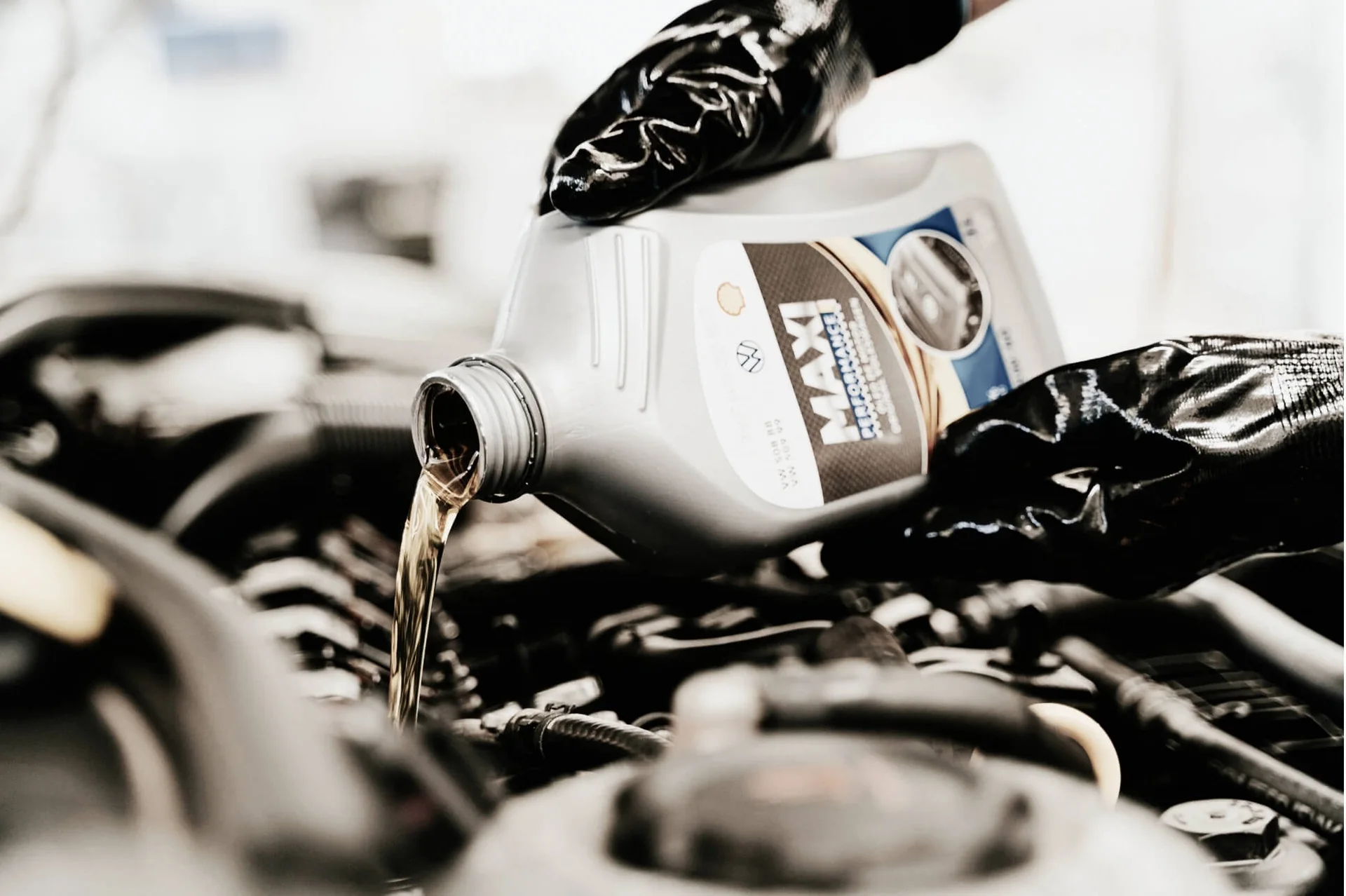Fresh engine oil being poured into an engine